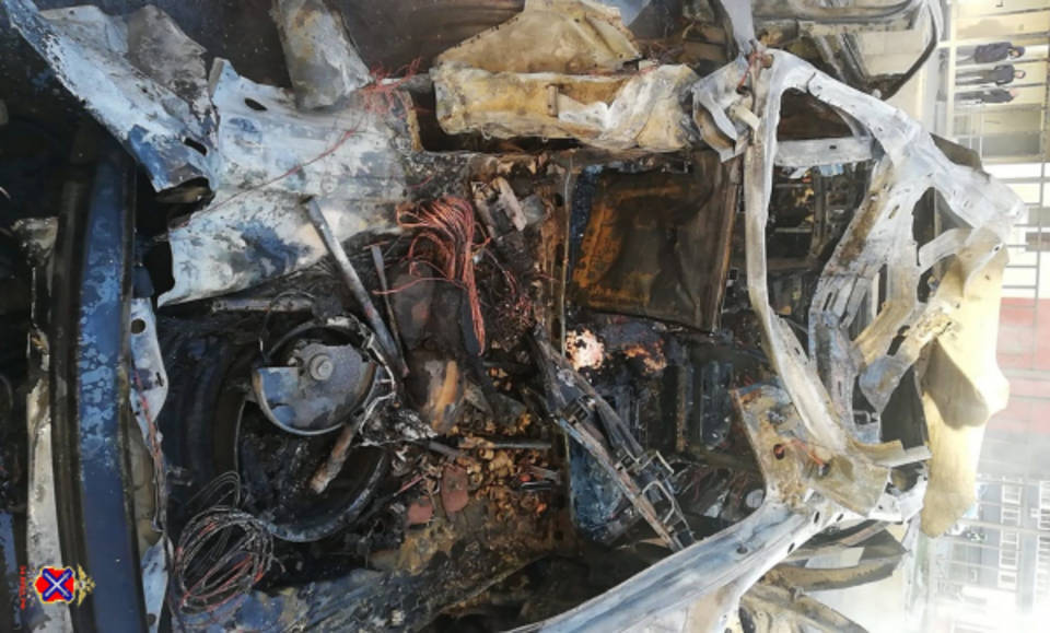 Машина после взрыва. Обгоревшее тело в машине. В Волгограде взорвалась машина.